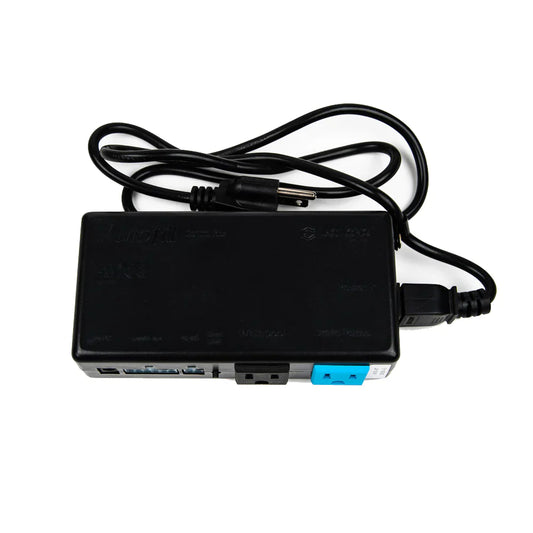 Black electronic device with multiple ports and a power cable on a white background
